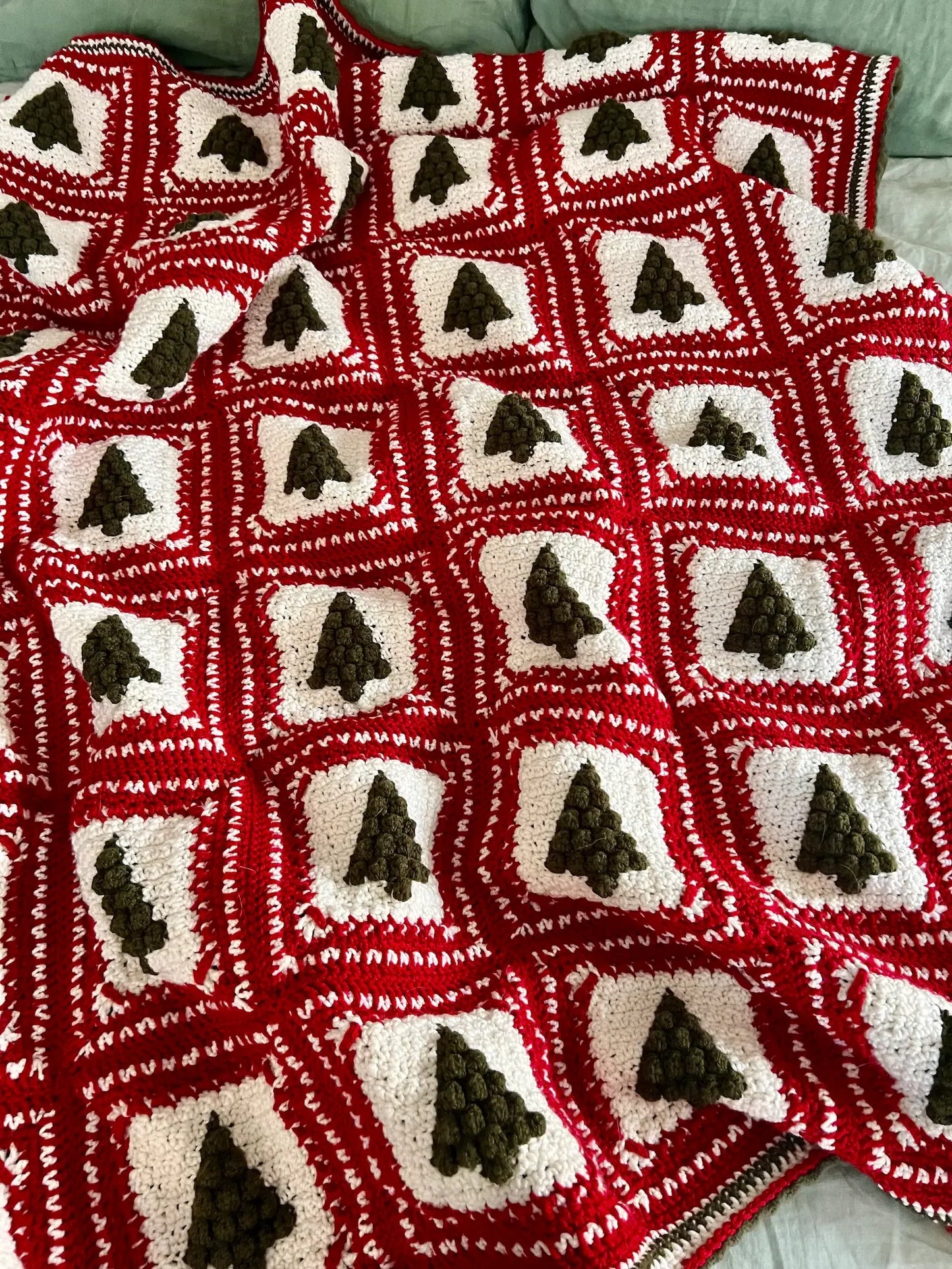 Close-up of green and red granny squares from the Christmas Tree crochet pattern.