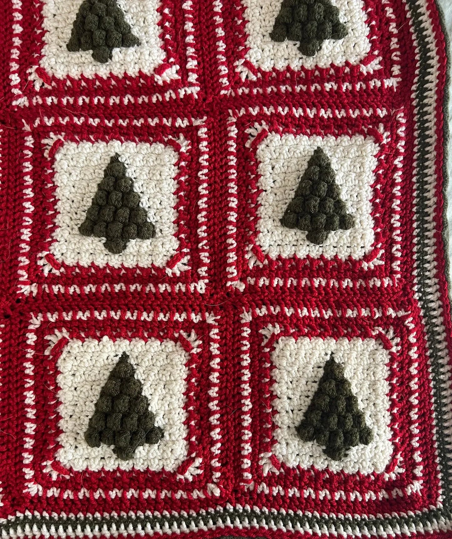 Close-up of green and red granny squares from the Christmas Tree crochet pattern.