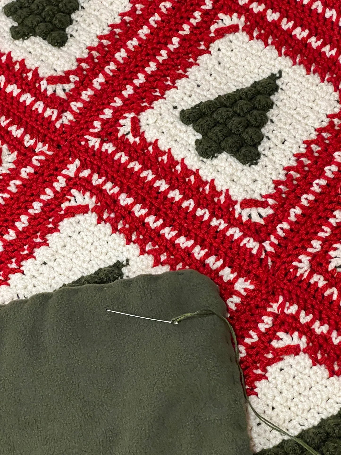 Close-up of green and red granny squares from the Christmas Tree crochet pattern.