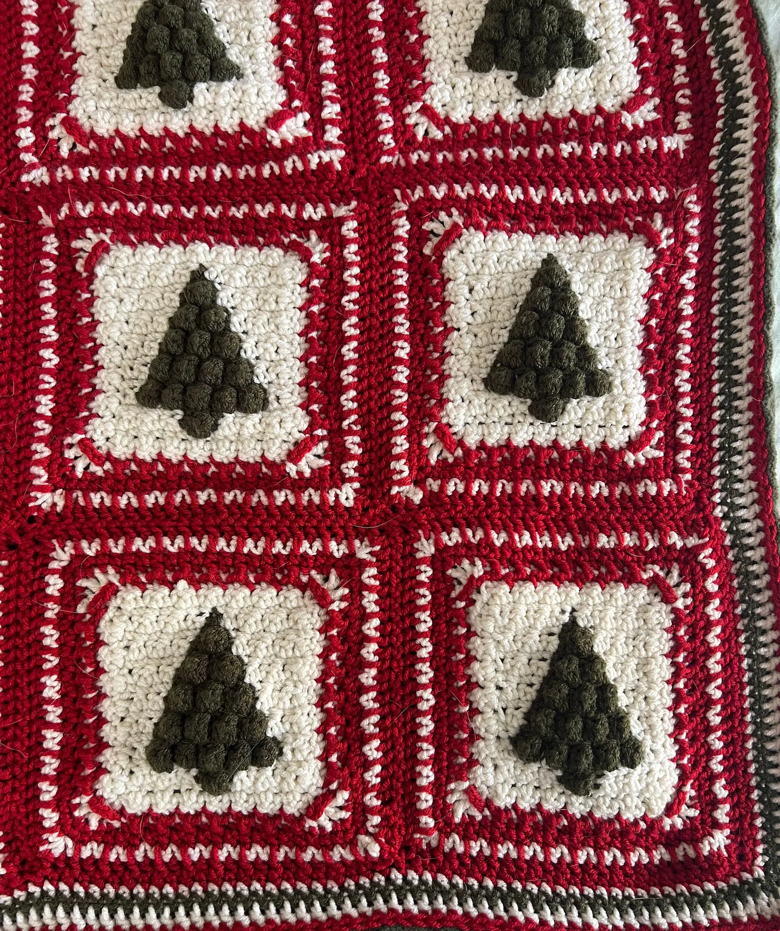 Close-up of green and red granny squares from the Christmas Tree crochet pattern.
