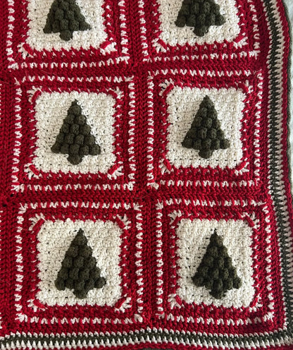Close-up of green and red granny squares from the Christmas Tree crochet pattern.
