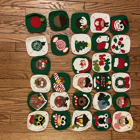 Collection of crochet christmas granny squares with various designs on a wooden surface