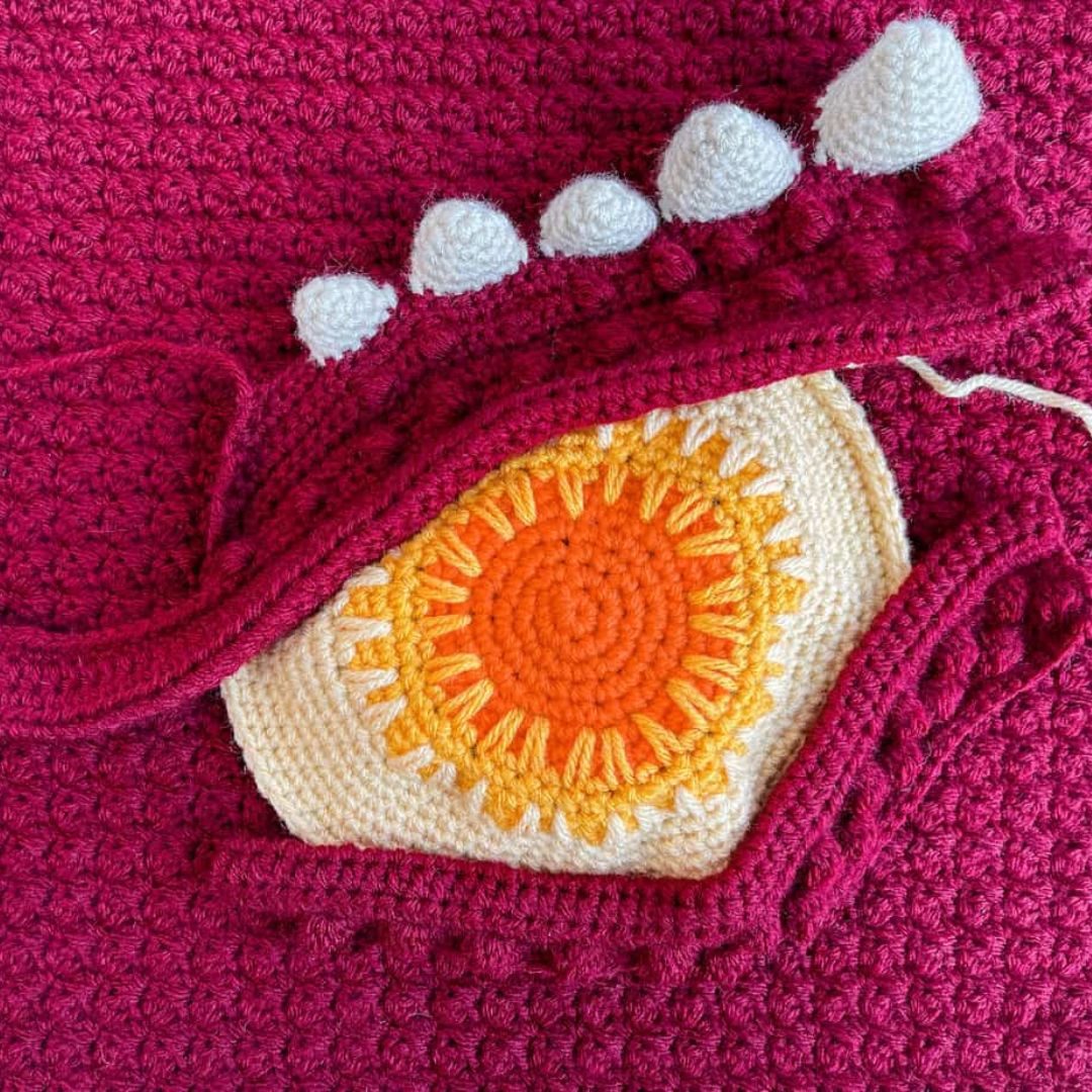 Close-up of an unfinished crochet dragon eye pillow
