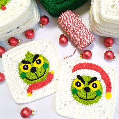 Two crocheted granny squares with Grinch faces surrounded by Christmas decorations on a white background.