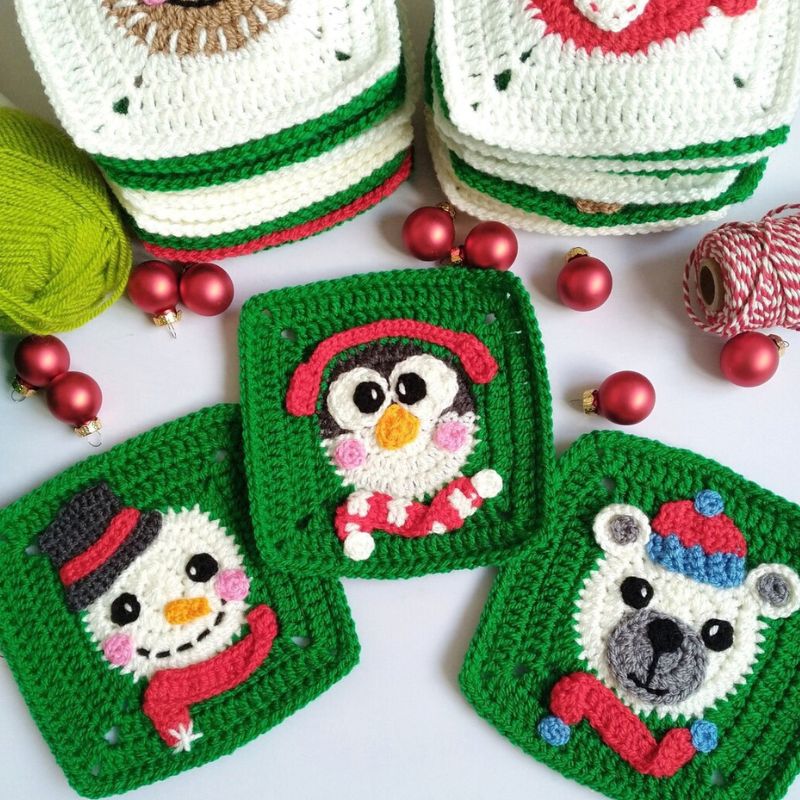 Crocheted granny squares with penguin, snowman, and bear designs on a white background with Christmas decorations.