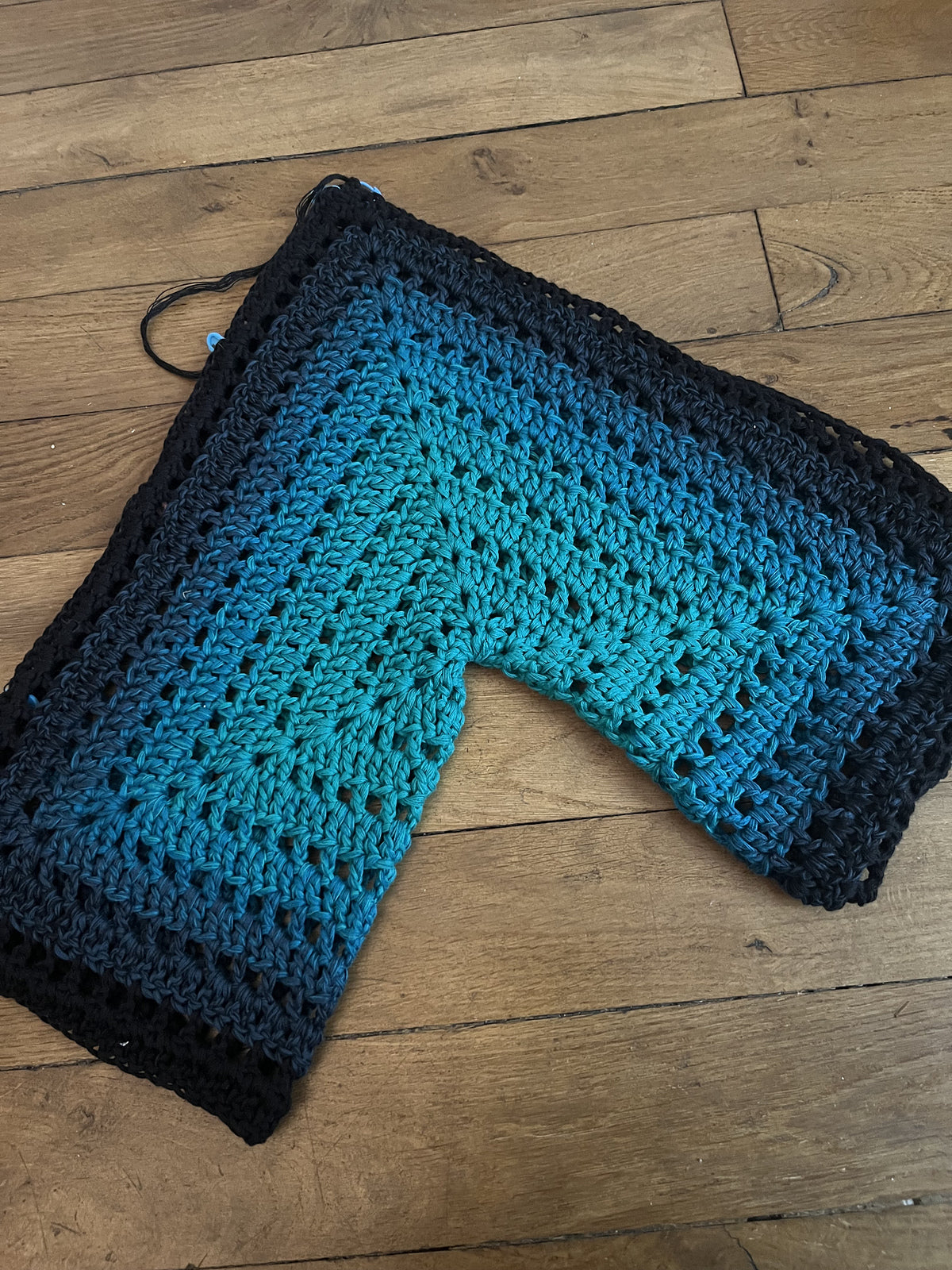 Hexagon cardigan crochet pattern laid flat on a wooden surface showing stitch details