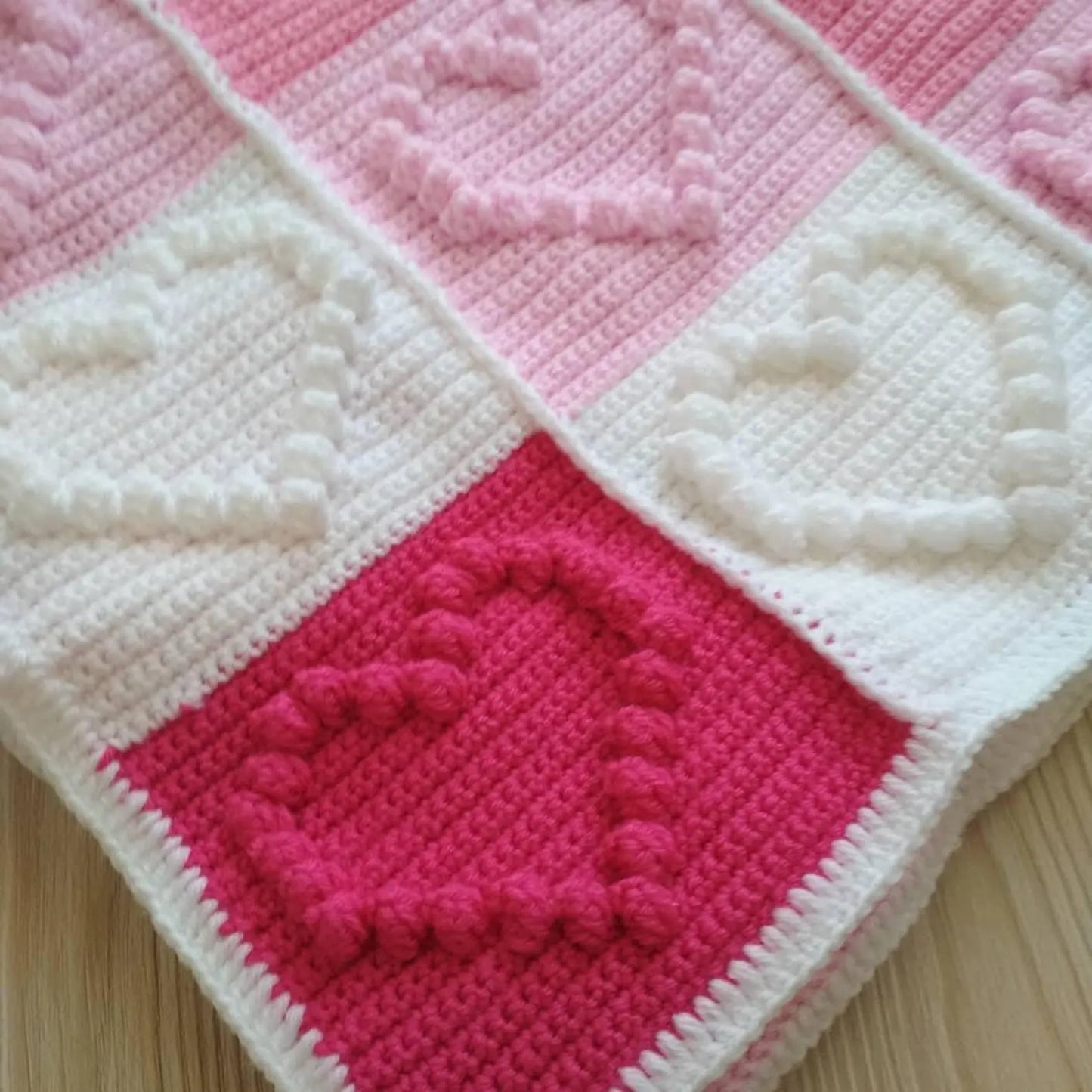 Close-up of heart stitches in baby blanket crochet pattern