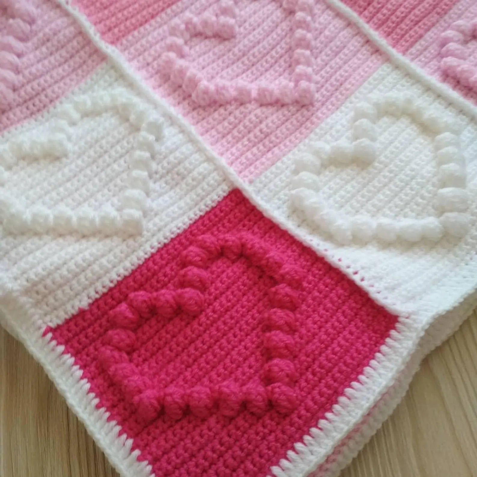 Close-up of heart stitches in baby blanket crochet pattern