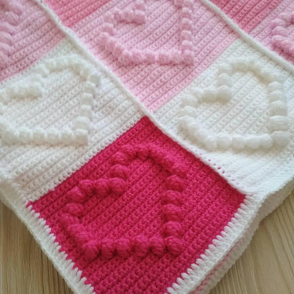 Close-up of heart stitches in baby blanket crochet pattern
