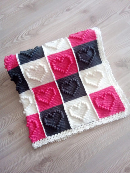 Crocheted blanket with heart motifs